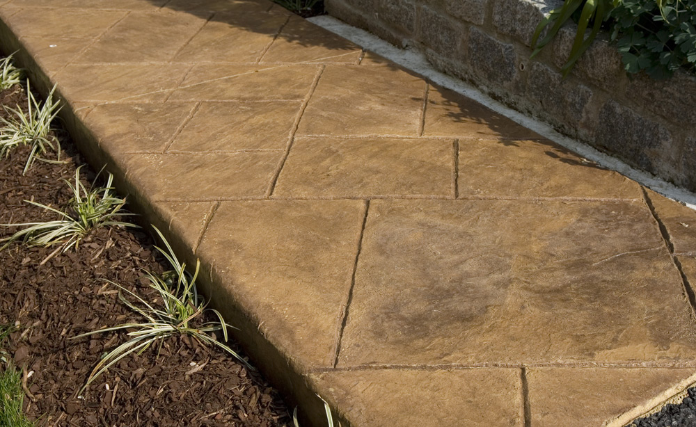 Stamped concrete slab walkway in grass