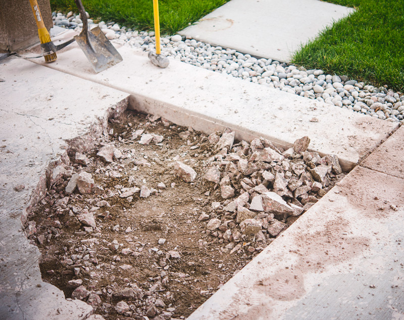 broken side walk being repaired
