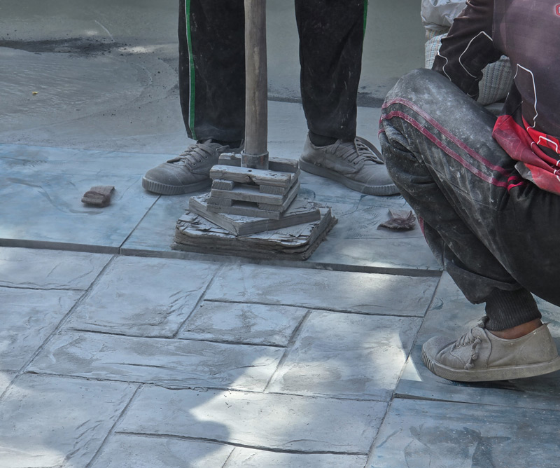 stamped-concrete-process workers stamping in the pattern for stamped Concrete